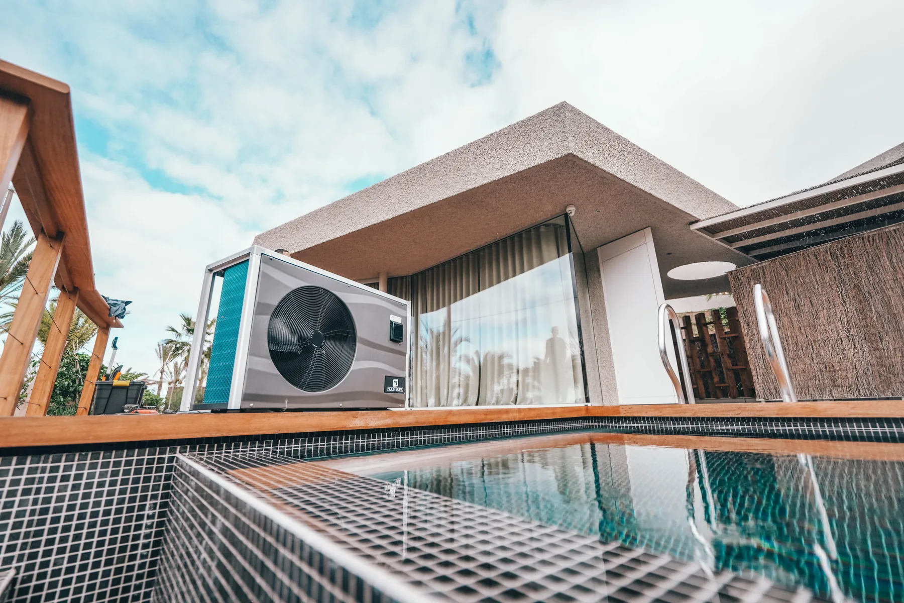 Pool heat pump installed beside a pool