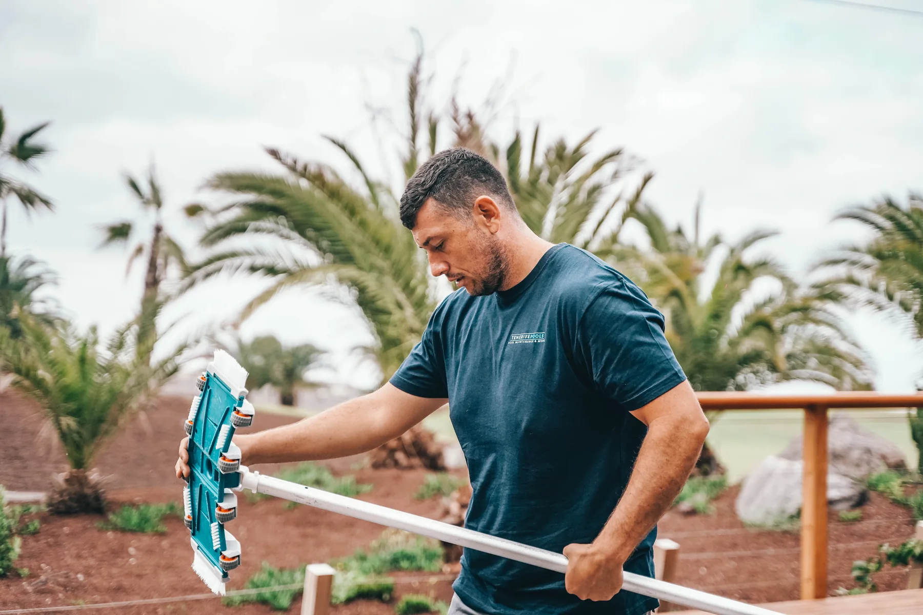 Tenerife Pools technician cleaning a private pool